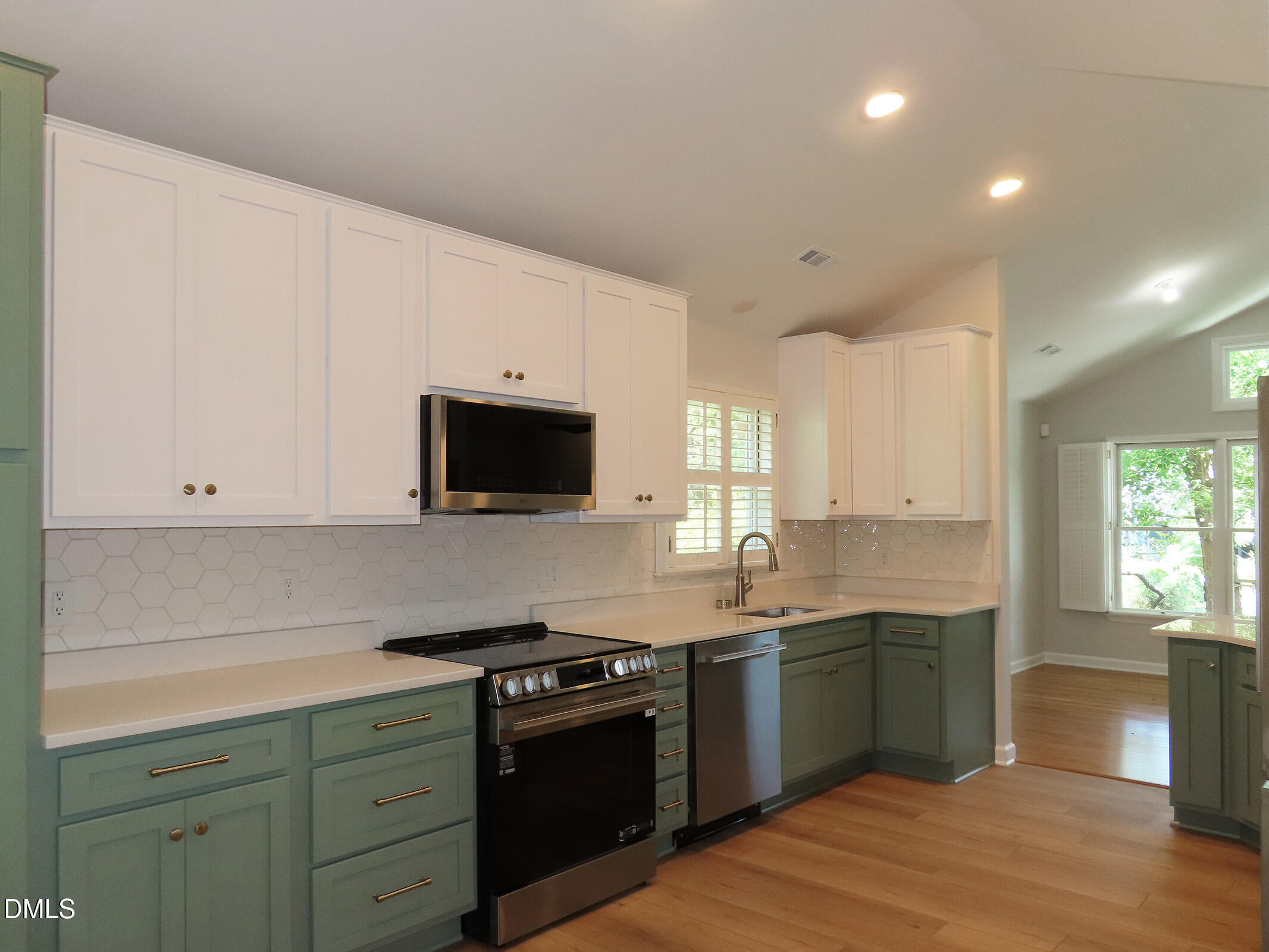 120 Weatherhill Point Carrboro, NC 27510 - Photo 6 of 25 a kitchen with stainless steel appliances granite countertop a sink dishwasher a stove and a refrigerator with wooden floor
