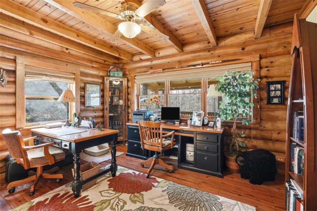 1401 Adair Mill Road Cleveland, GA 30528 - Photo 22 of 62 a room with lots of wooden furniture and glass windows