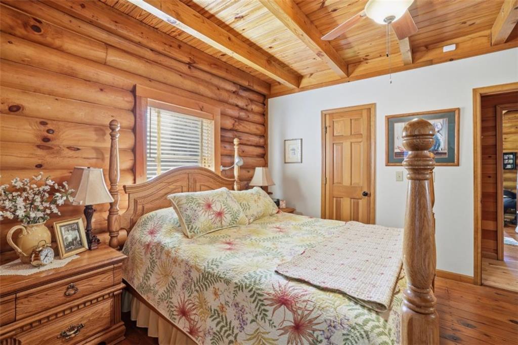 1401 Adair Mill Road Cleveland, GA 30528 - Photo 24 of 62 a bedroom with a bed and wooden floor