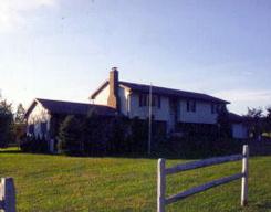 a view of a house with wooden fence
