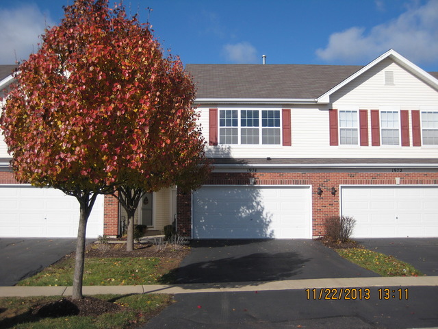 a front view of a house with garage