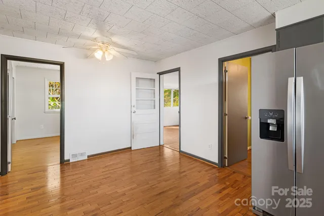 a front view of a house with a yard and trees