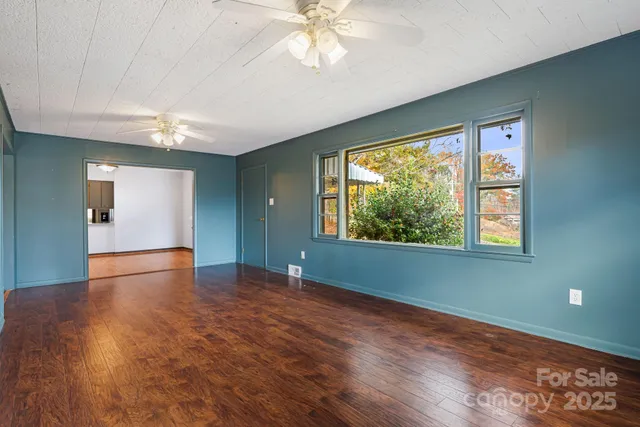 a bedroom with furniture and a large window