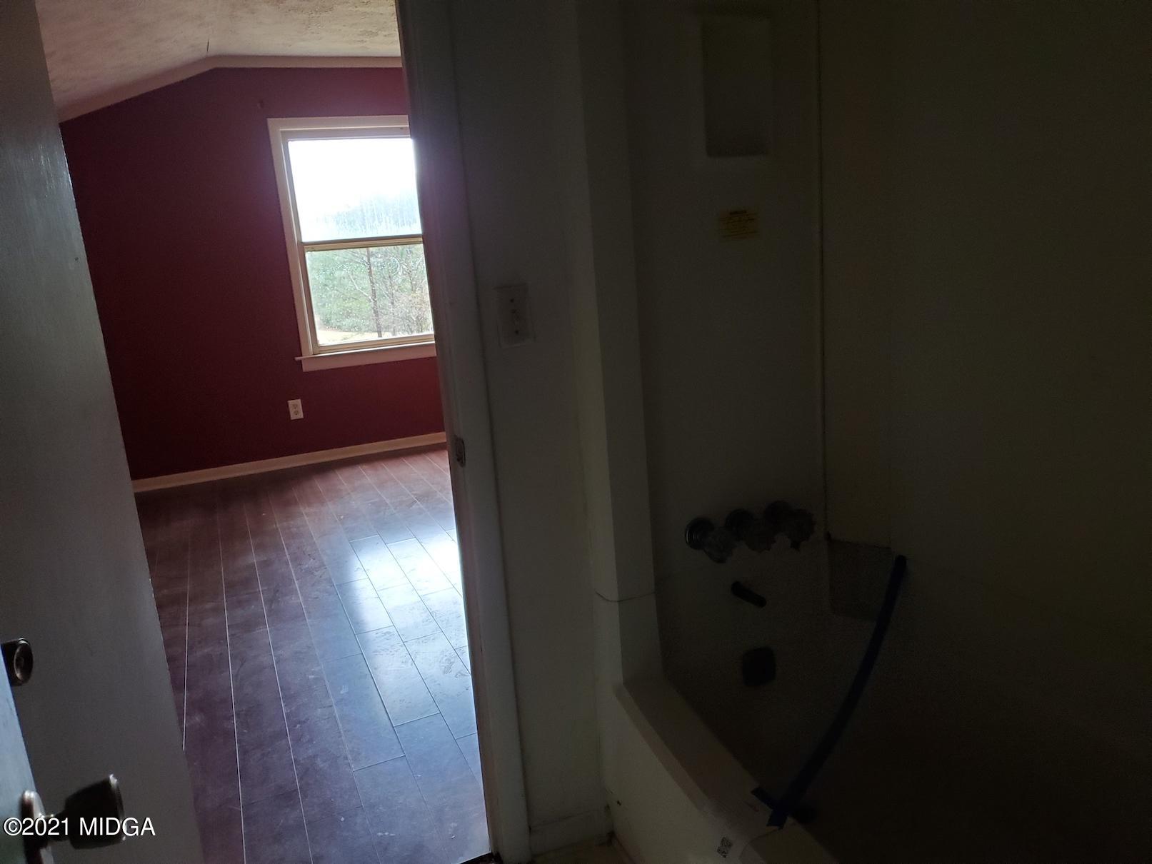 462 Thomas Ferry Road Jackson, GA 30233 - Photo 16 of 27 a view of hallway with window and wooden floor