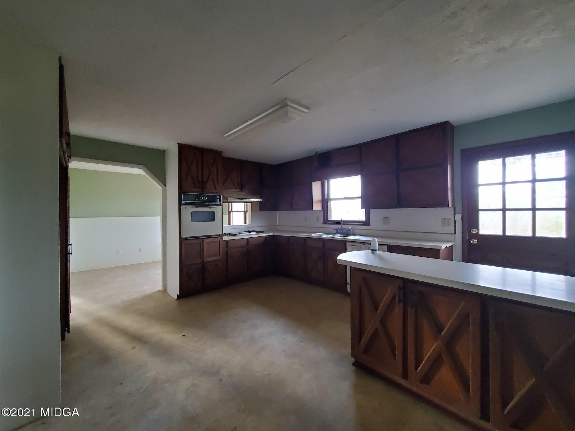 462 Thomas Ferry Road Jackson, GA 30233 - Photo 8 of 27 a kitchen with stainless steel appliances kitchen island granite countertop a stove a sink and a microwave