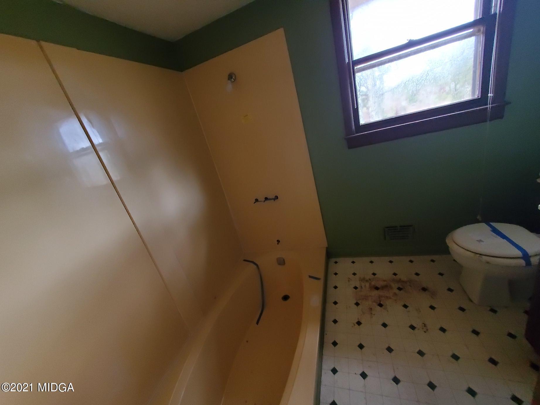 462 Thomas Ferry Road Jackson, GA 30233 - Photo 10 of 27 a bathroom with a sink a toilet a window and a mirror