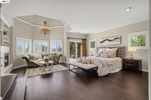 a bedroom with a bed dresser and window