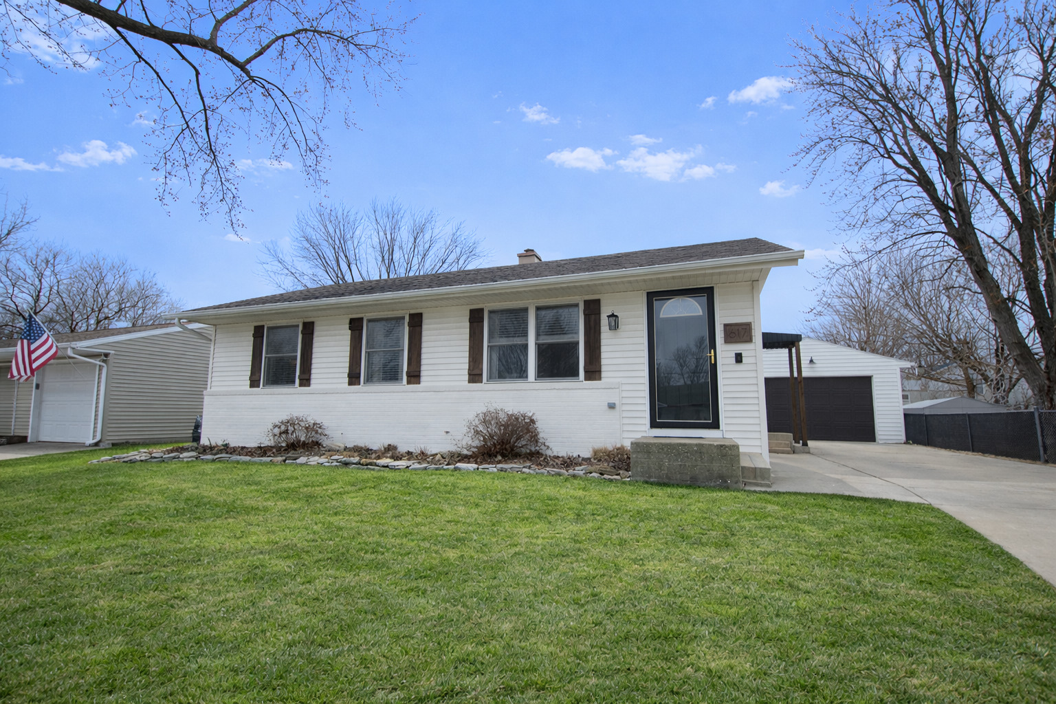 a front view of a house with a garden and yard