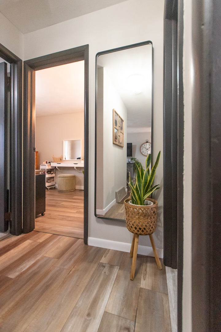 617 Orchard Street Dixon, IL 61021 - Photo 18 of 32 a view of a hallway with wooden floor and a potted plant