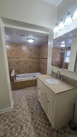 a bathroom with a granite countertop sink a toilet and a mirror