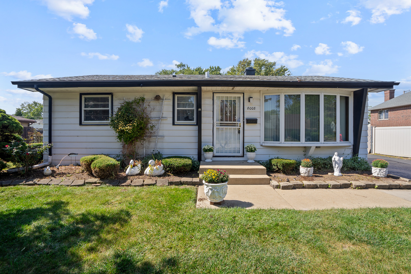 8008 Normandy Avenue Burbank, IL 60459 - Photo 1 of 41 a front view of a house with patio and garden