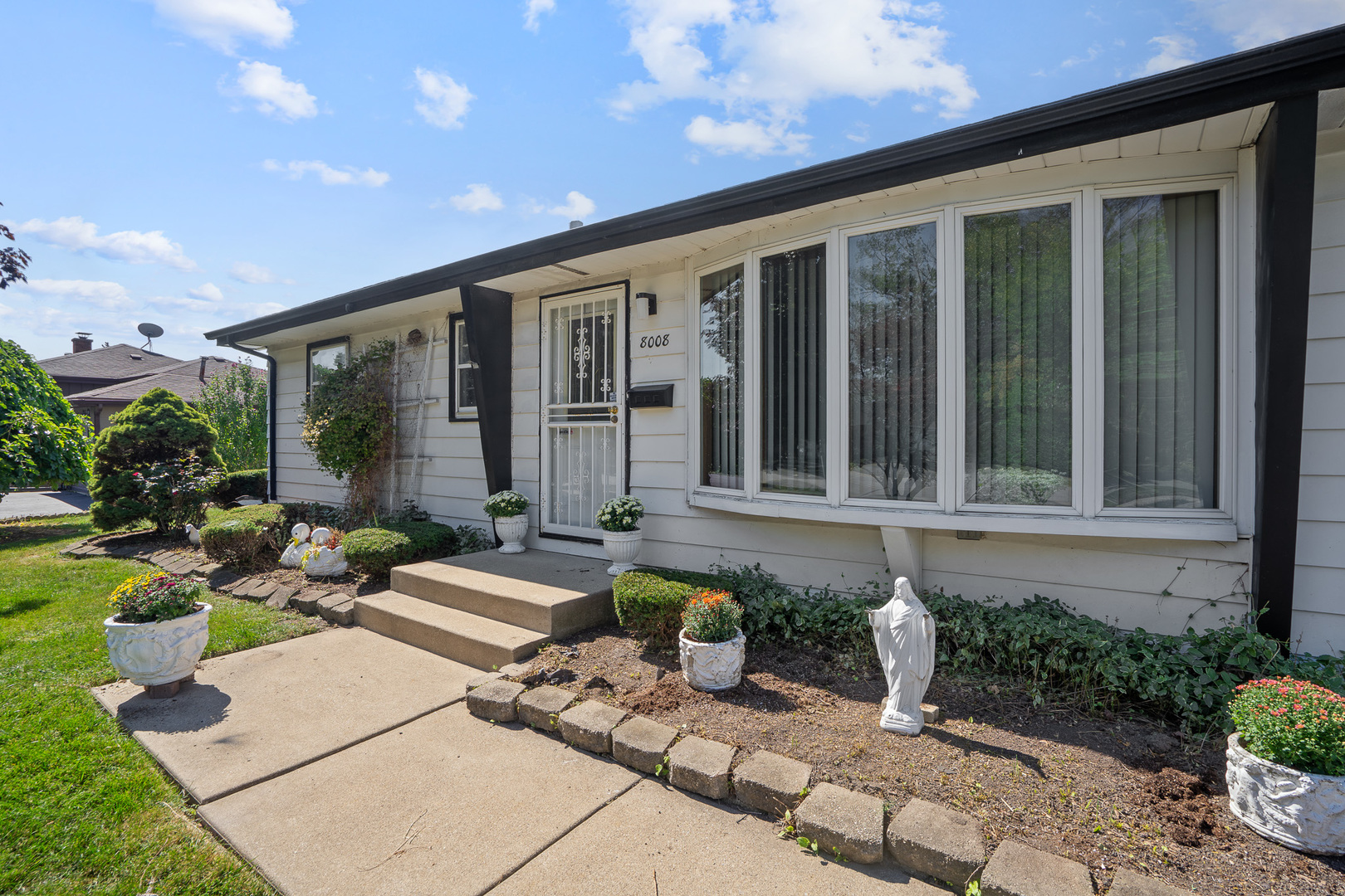 8008 Normandy Avenue Burbank, IL 60459 - Photo 38 of 41 a front view of a house with garden