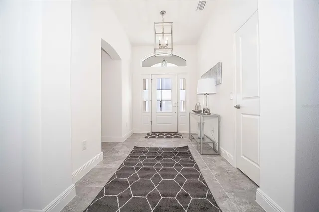 a dining hall with stainless steel appliances lots of white furniture a dining table and chairs