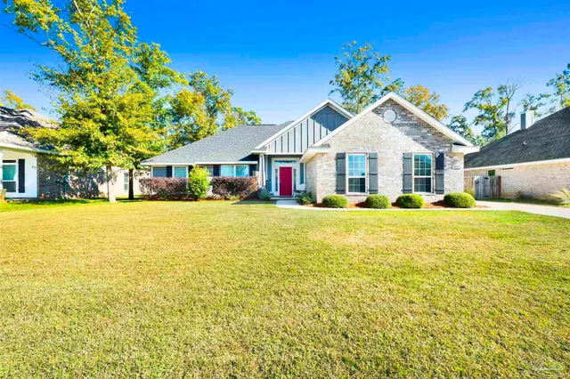 a view of house that has a big yard