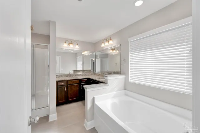 a large white kitchen with a large window