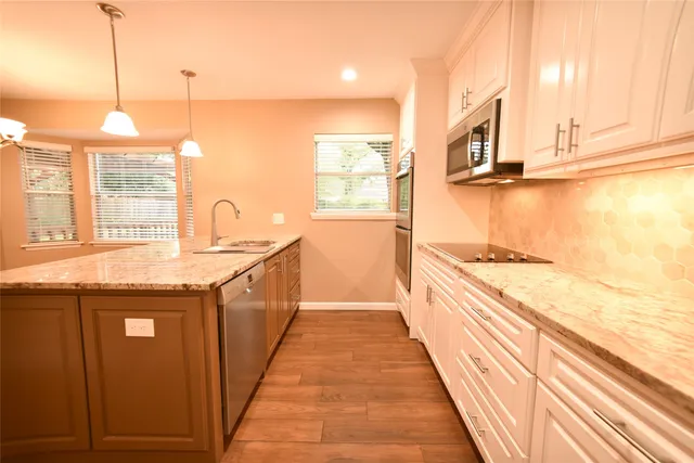 a kitchen with stainless steel appliances a refrigerator and cabinets
