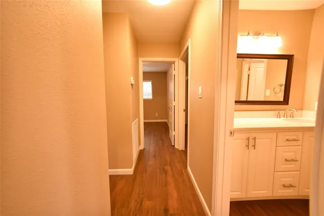 a bathroom with a granite countertop sink and a large mirror