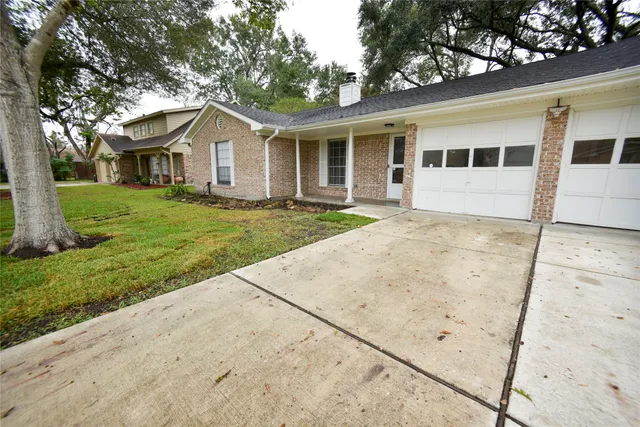 a view of a white house with a yard