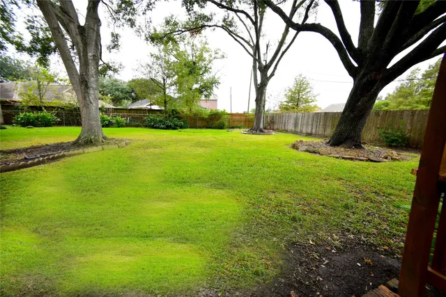 a view of an house with backyard space and garden