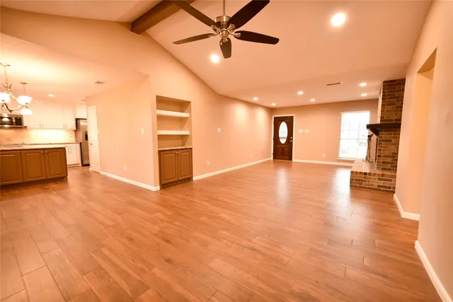 a view of a livingroom with furniture wooden floor and window