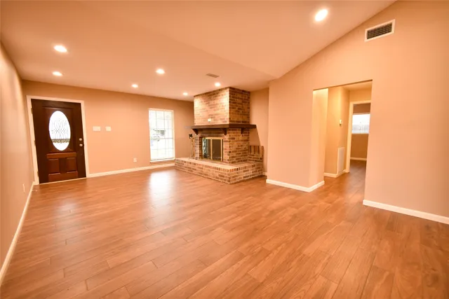 a view of a kitchen with a stove cabinets and wooden floor