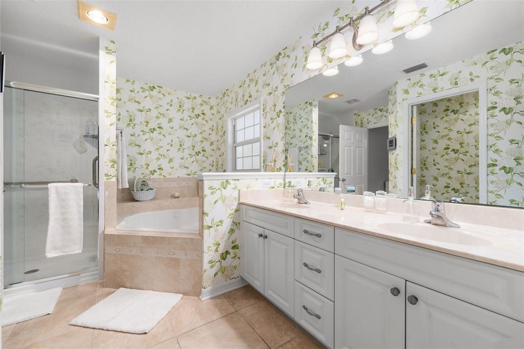7418 White Oaks Road Alachua, FL 32615 - Photo 16 of 46 a bathroom with a double vanity sink mirror and bathtub