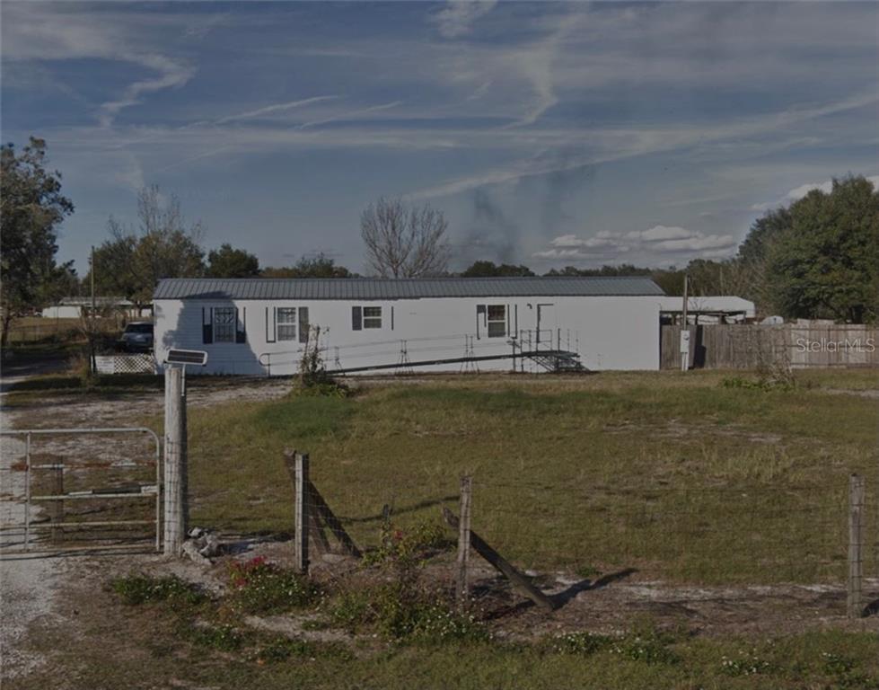 5840 Barnes Road Bartow, FL 33830 - Photo 1 of 1 a view of a lake with a house in the background
