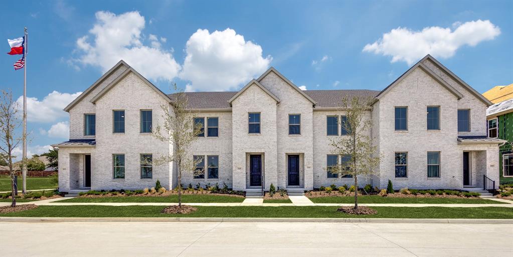 a view of a white building among the side of a road and building
