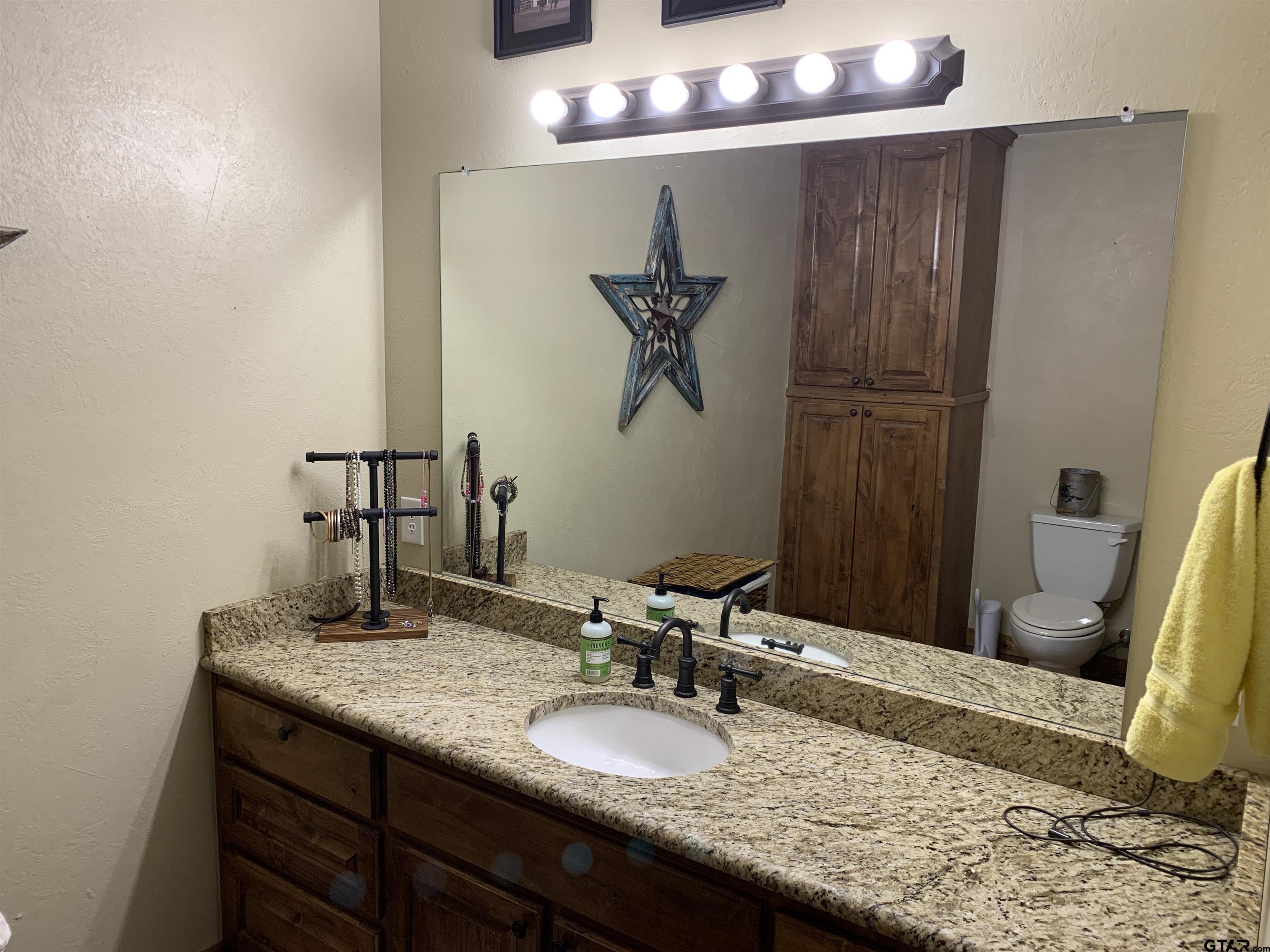 16650 C R 3419 Brownsboro, TX 75756 - Photo 15 of 36 a bathroom with a granite countertop sink and a mirror