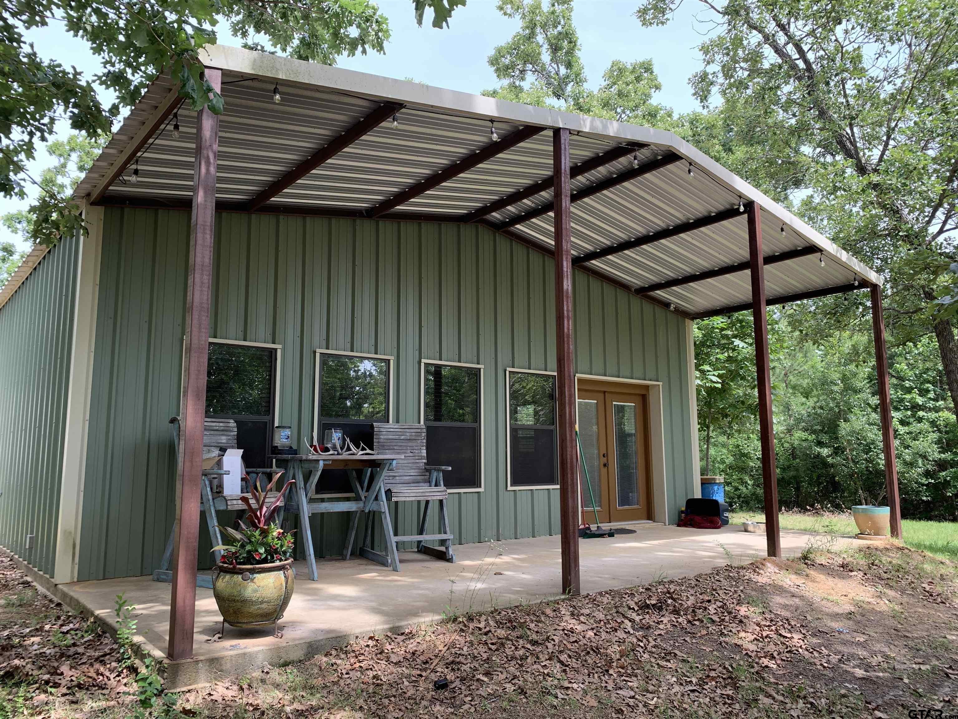 16650 C R 3419 Brownsboro, TX 75756 - Photo 21 of 36 a patio with a table and chairs under an umbrella