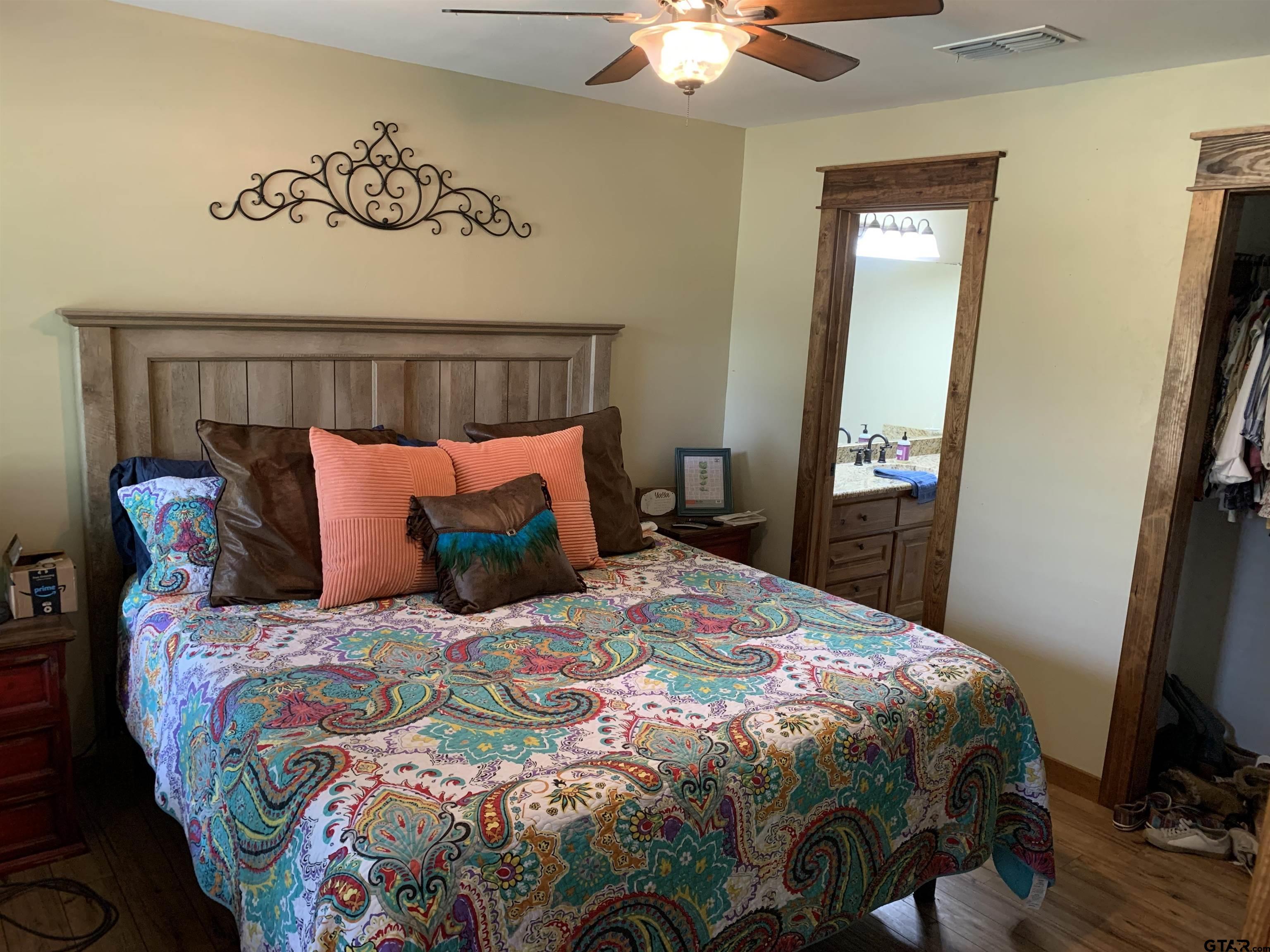 16650 C R 3419 Brownsboro, TX 75756 - Photo 9 of 36 a bedroom with a bed and a chandelier