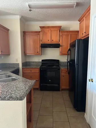 a kitchen with a refrigerator and a sink