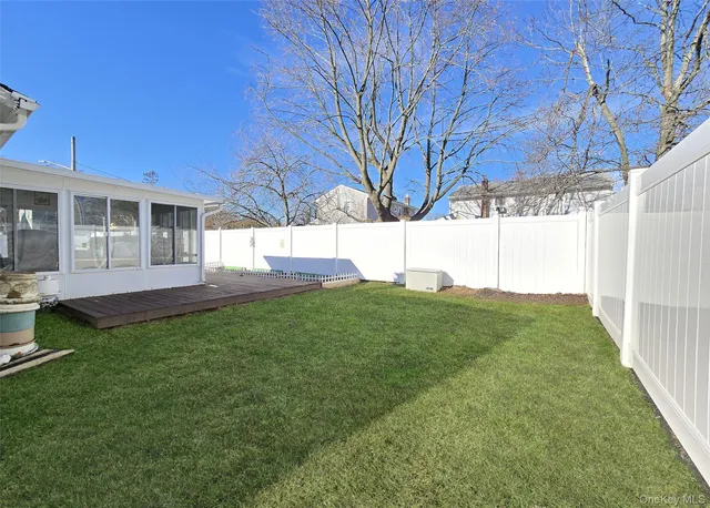 a view of a house with backyard and a tree