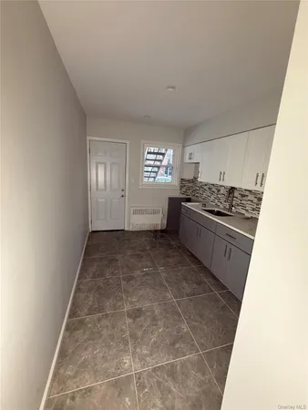 a kitchen with a stove top oven and cabinets