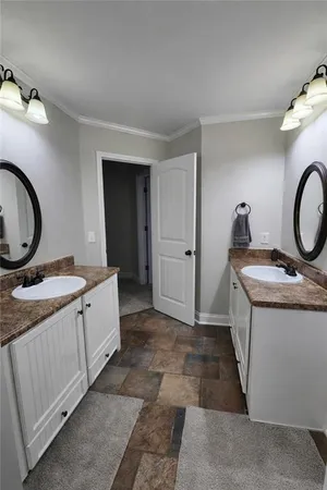 a bathroom with a granite countertop sink a toilet and a mirror