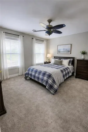 a spacious bedroom with a bed and window