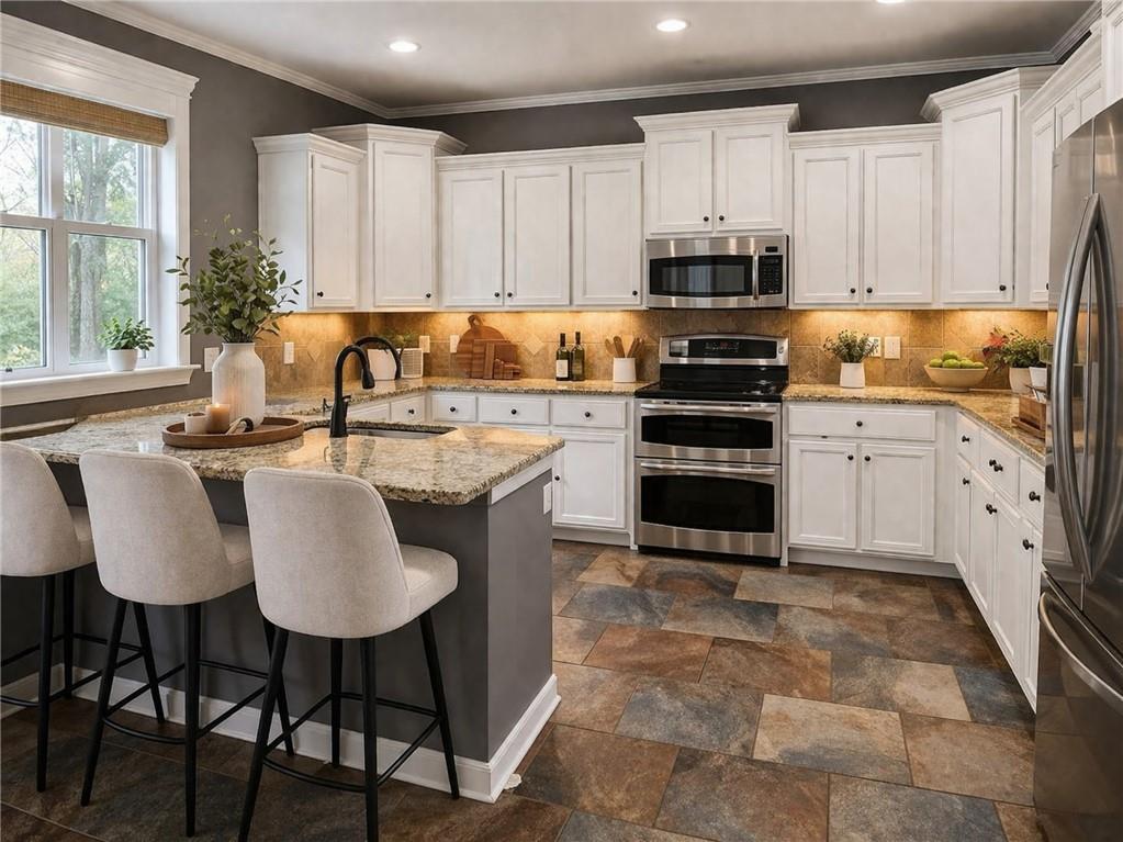 249 Serenity Loop Cataula, GA 31804 - Photo 4 of 16 a kitchen with stainless steel appliances a stove a sink a microwave a refrigerator and white cabinets