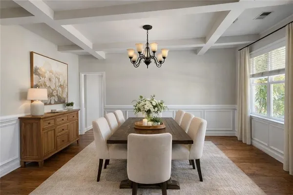 a dining room with furniture a window and a chandelier