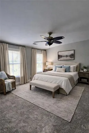 a bedroom with a large bed and a large window