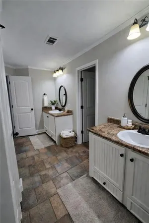 a living room with a sink furniture and a mirror