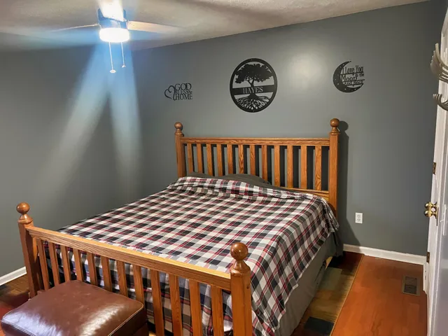 a bedroom with a bed and a chandelier