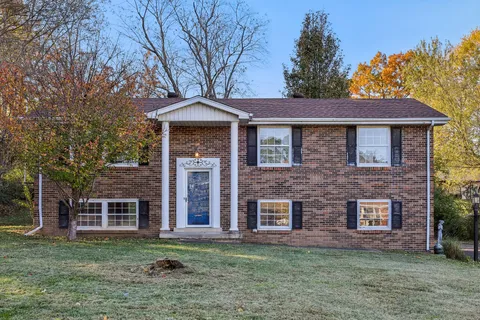 a front view of a house with a garden