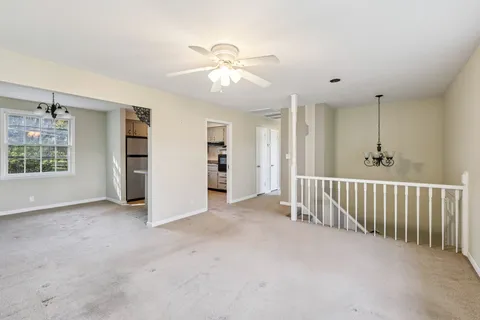 an empty room with closet and windows