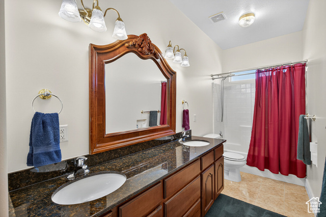 4768 East Hickman Canyon Road Stockton, UT 84071 - Photo 26 of 85 Second floor bathroom featuring shower / bath combo with shower curtain, double vanity, and light tile patterned floors.