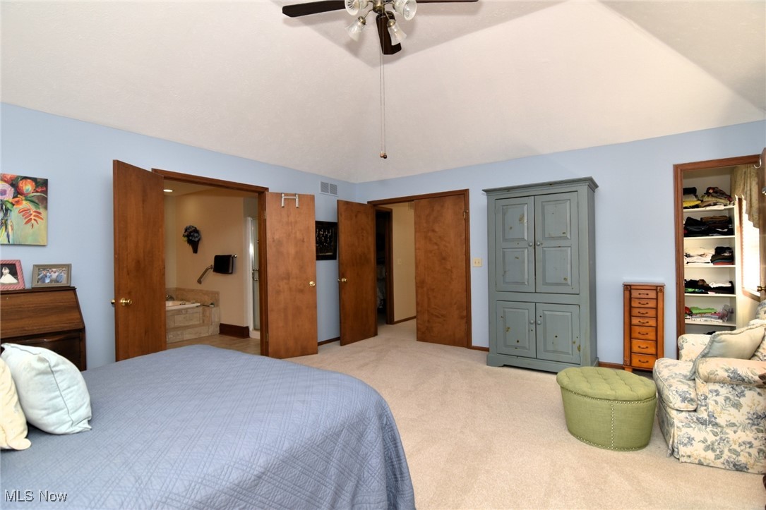 5510 Som Center Road Solon, OH 44139 - Photo 25 of 38 Bedroom featuring light colored carpet, ceiling fan, vaulted ceiling, and a closet