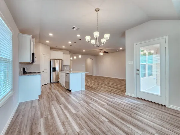 a view of a kitchen with a dishwasher cabinets and wooden floor