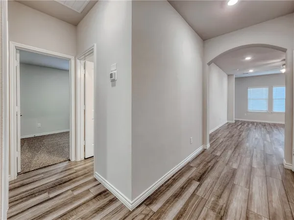 a view of a hallway with wooden floor