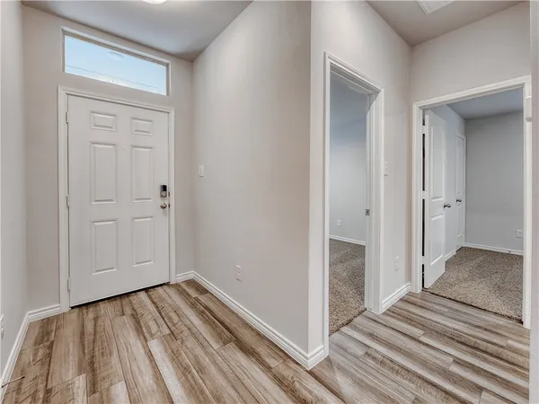 a view of a room with wooden floor