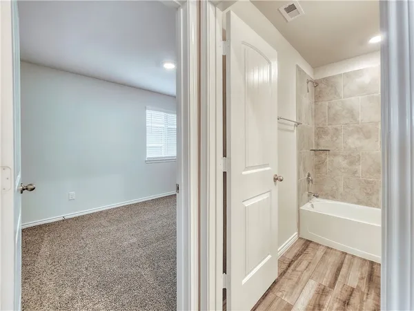 a bathroom with a bathtub and shower