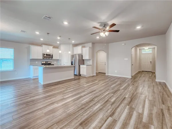 a view of a kitchen with a sink and a refrigerator